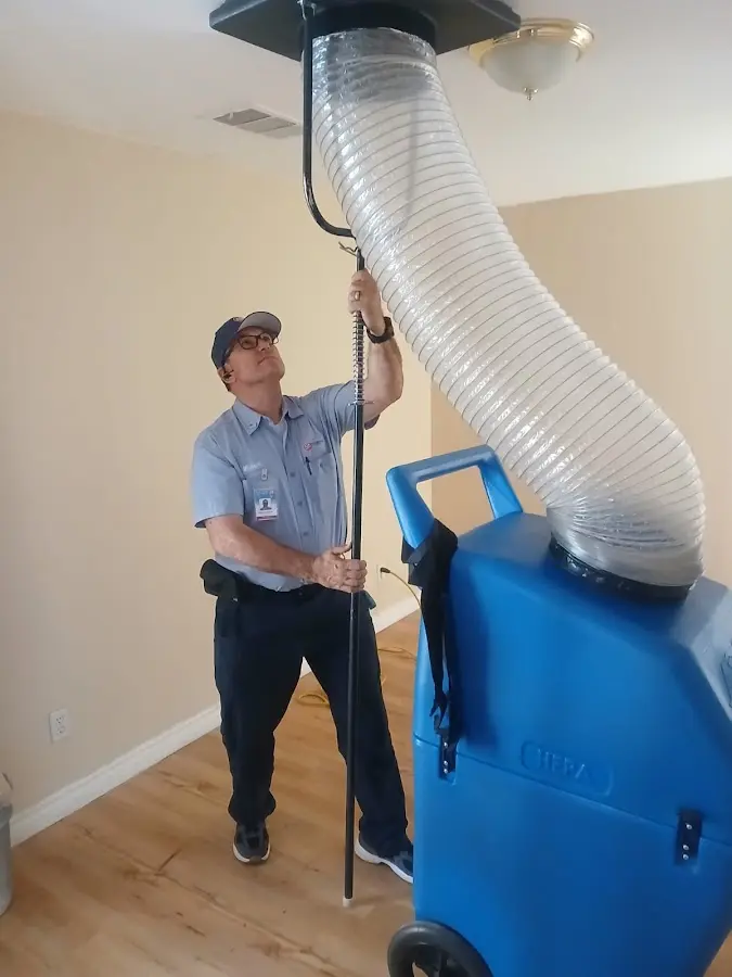 Furnace Tune-Up technician using HEPA equipment in Hondo